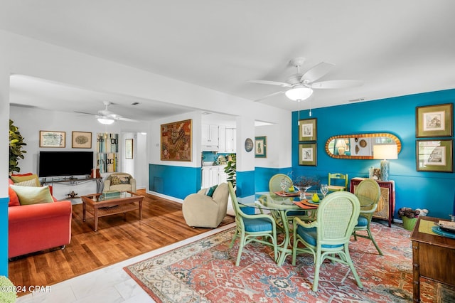 dining room featuring ceiling fan and wood-type flooring