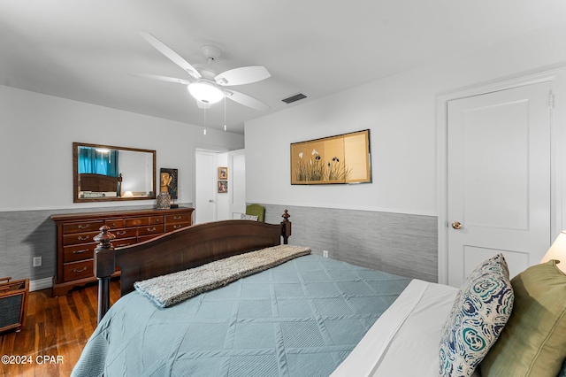 bedroom with dark hardwood / wood-style floors and ceiling fan