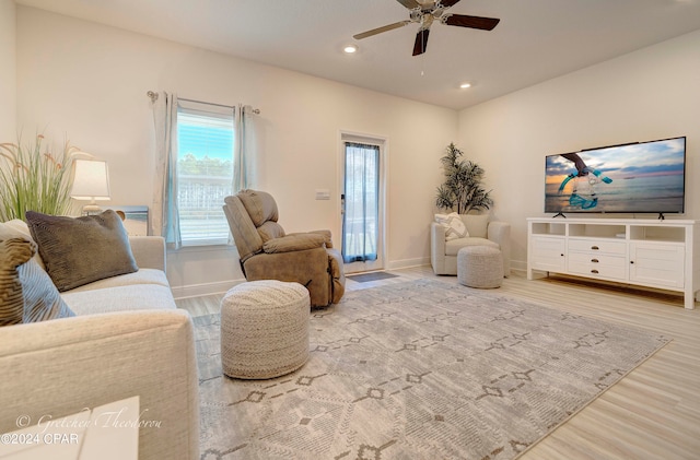 living room with ceiling fan and light wood-type flooring