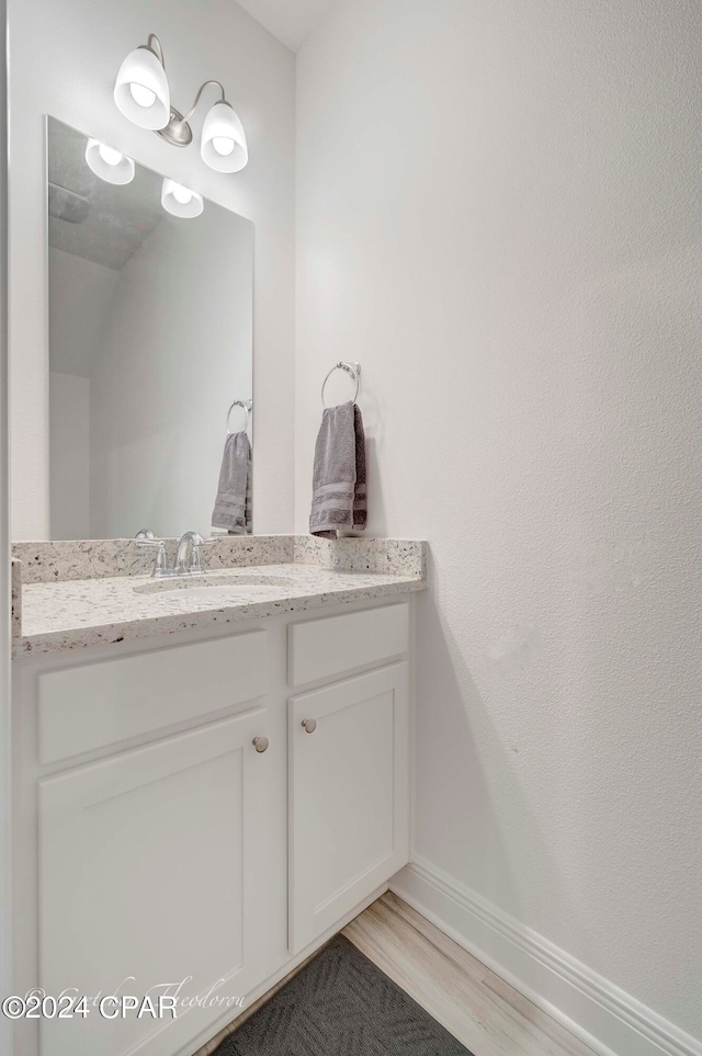 bathroom with vanity and hardwood / wood-style floors