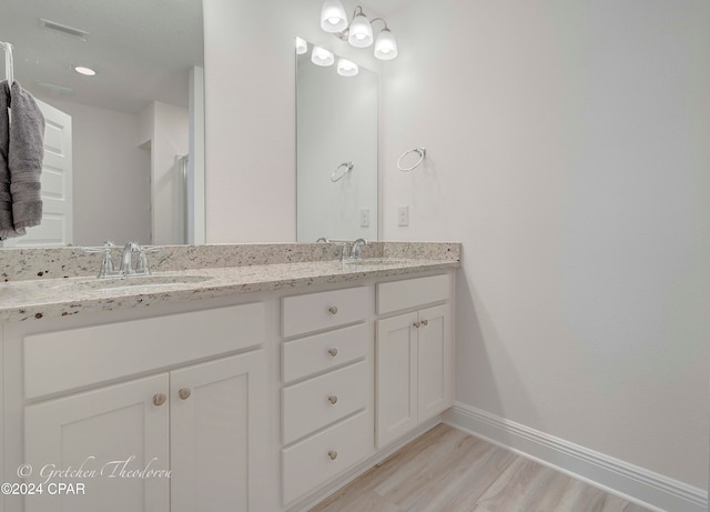 bathroom with hardwood / wood-style floors and vanity