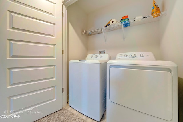 clothes washing area featuring washer and clothes dryer