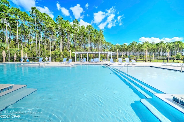 view of swimming pool with a pergola and a patio area