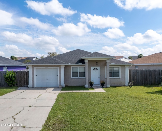 single story home featuring a front yard and a garage