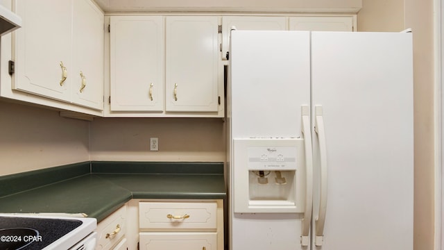 kitchen with white appliances and white cabinets