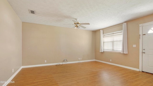 interior space with ceiling fan, a textured ceiling, and hardwood / wood-style floors