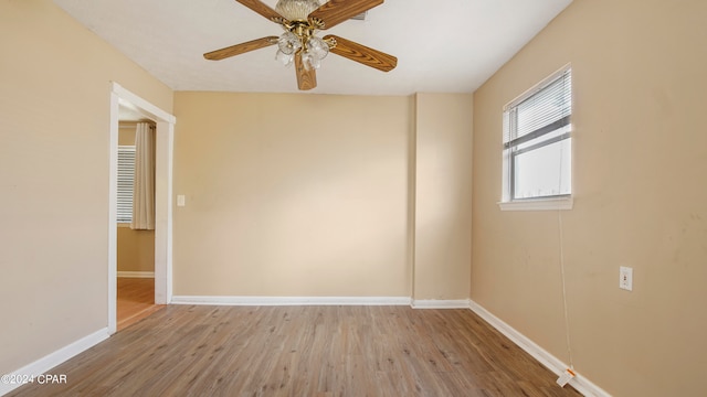 empty room with ceiling fan and light wood-type flooring