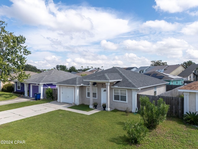 ranch-style house with a garage and a front lawn