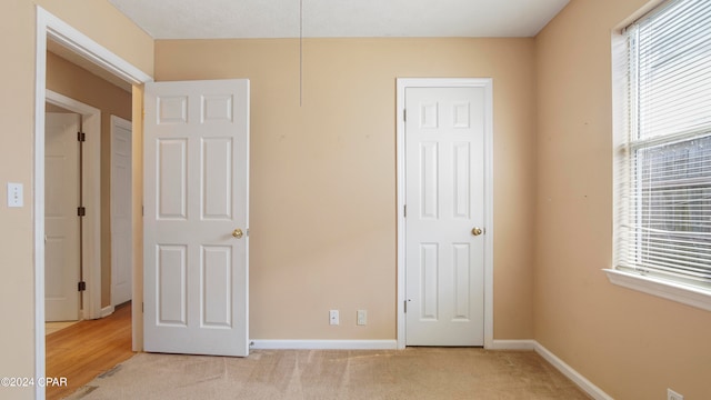 unfurnished bedroom featuring light colored carpet