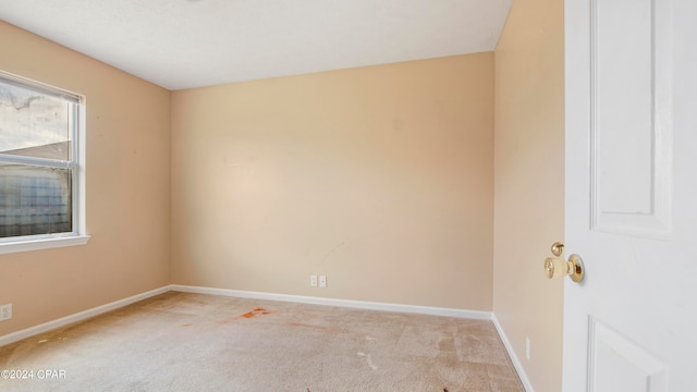 spare room with light colored carpet