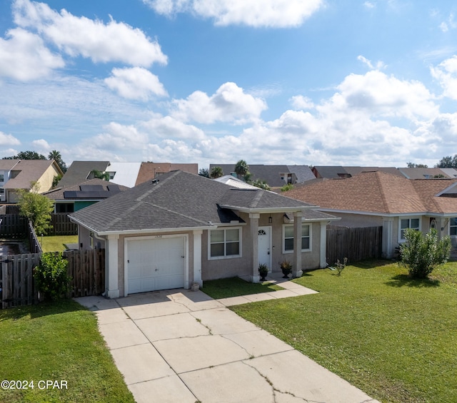 ranch-style home with a garage and a front lawn