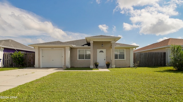 view of front of property with a front yard and a garage