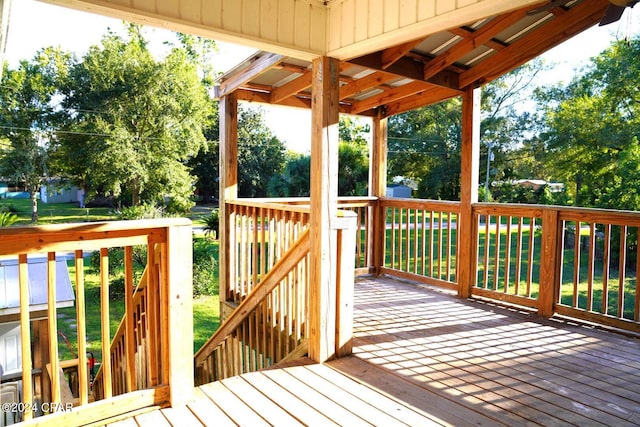 wooden deck featuring a yard