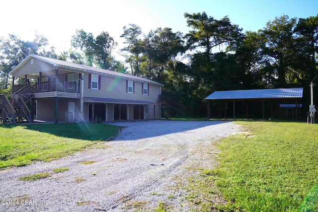 view of front of house featuring a carport, covered porch, and a front lawn