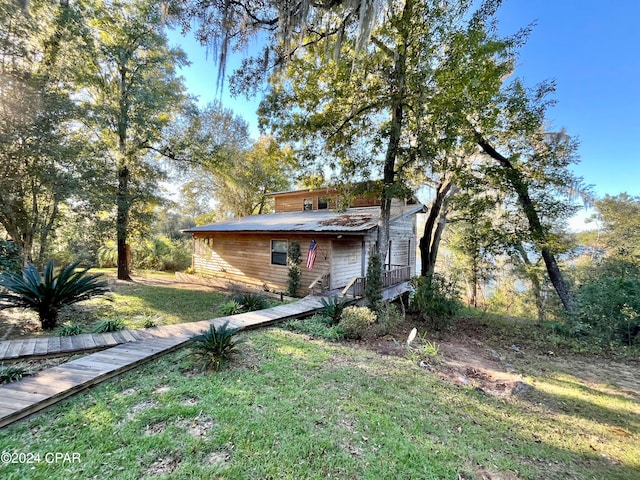 view of front of house with a front lawn and a wooden deck