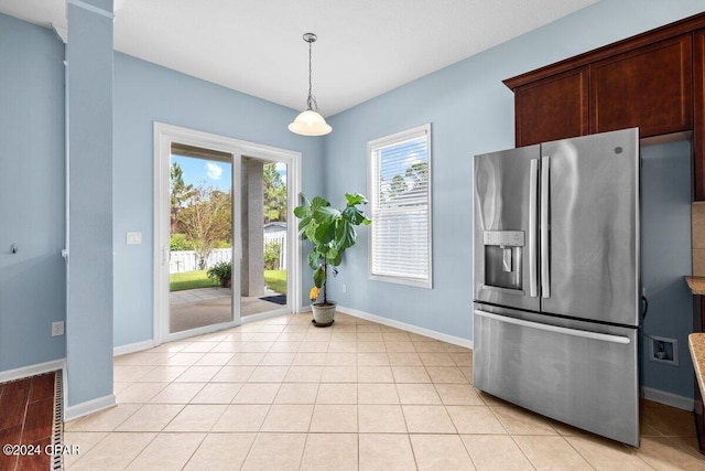 kitchen featuring light tile patterned floors, dark brown cabinetry, stainless steel fridge with ice dispenser, and decorative light fixtures