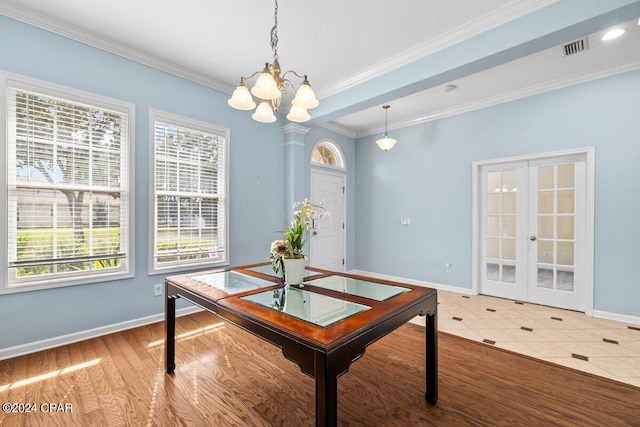 dining area with wood-type flooring, ornamental molding, french doors, and a wealth of natural light