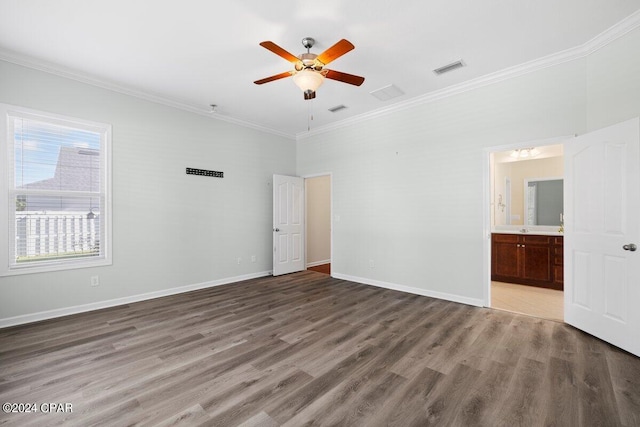 unfurnished bedroom with connected bathroom, ornamental molding, hardwood / wood-style floors, and ceiling fan