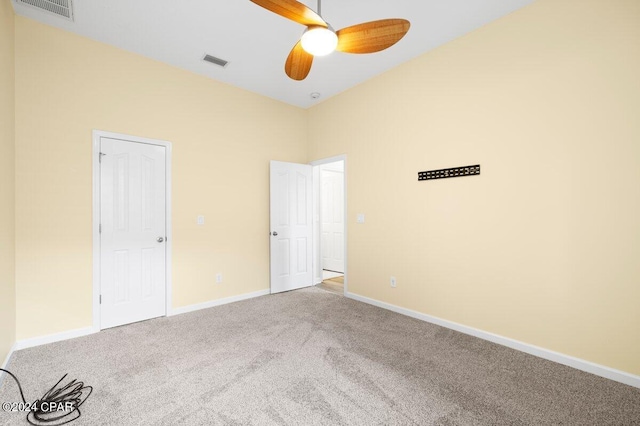 spare room with carpet flooring and ceiling fan