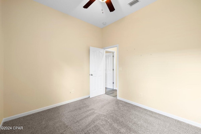 spare room with carpet and a towering ceiling