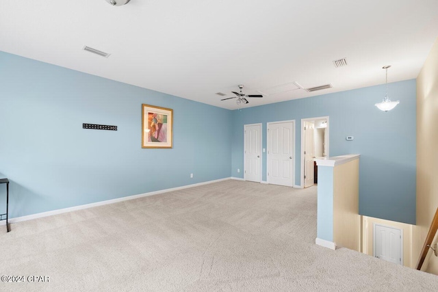 carpeted spare room with ceiling fan