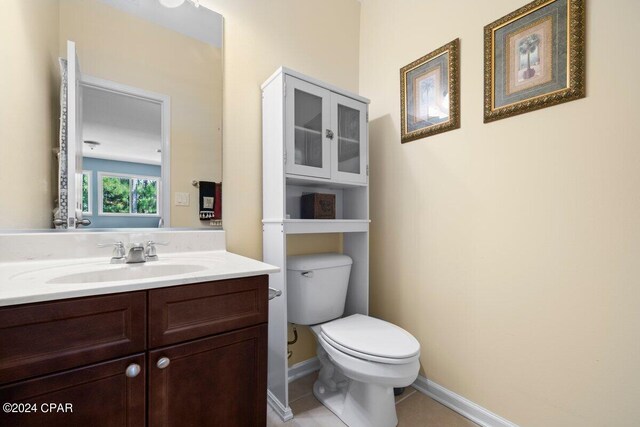 bathroom with tile patterned flooring, vanity, and toilet