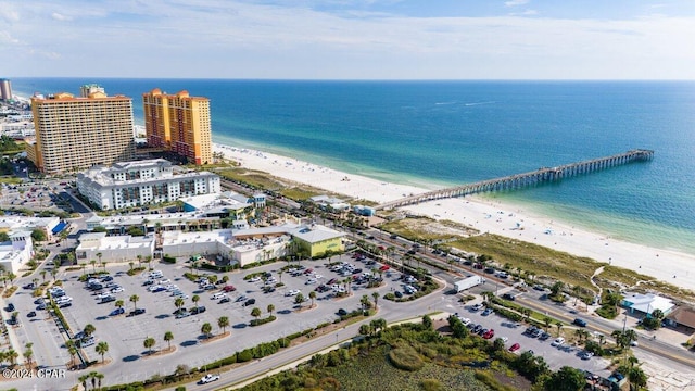 drone / aerial view featuring a water view and a beach view