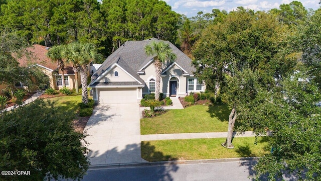 view of front of property with a garage and a front lawn