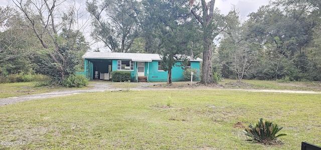 ranch-style home with a carport and a front yard