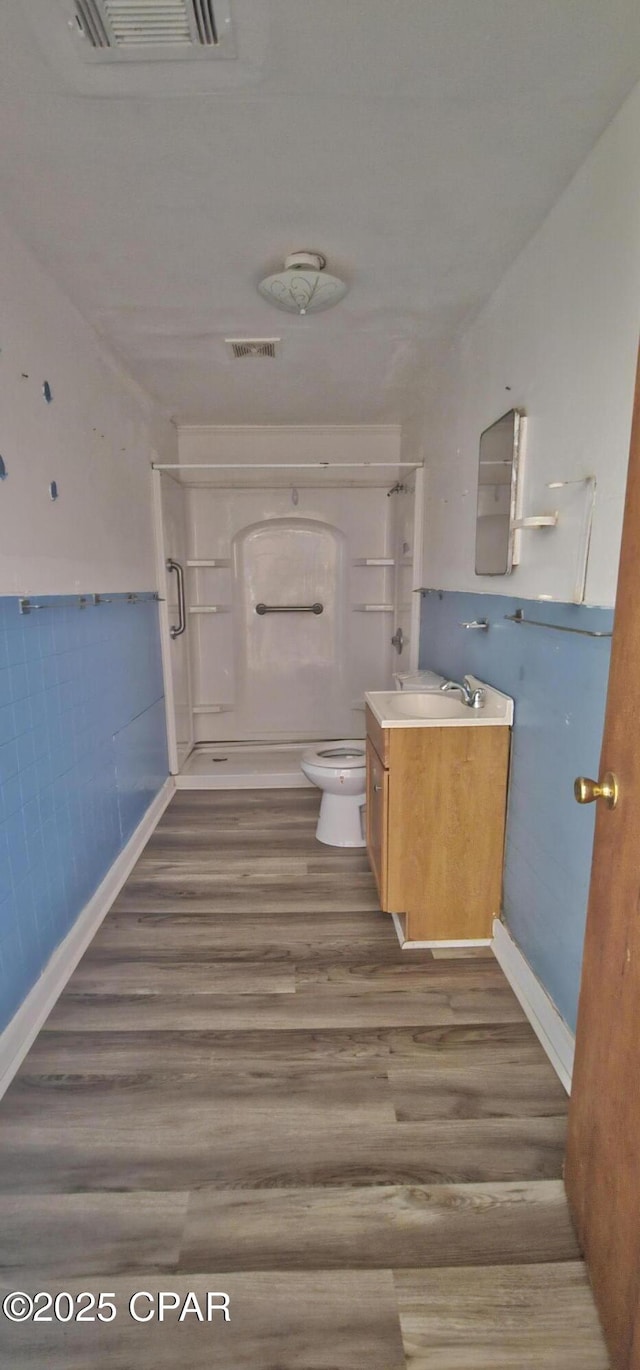 bathroom with vanity, hardwood / wood-style floors, and toilet