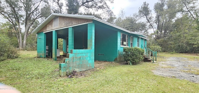 view of side of home with a lawn