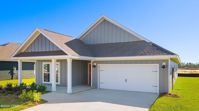 view of front of home with a front yard and a garage