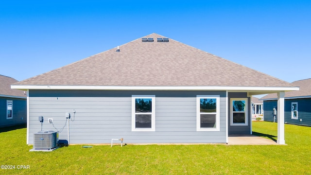 back of house with a lawn and central AC unit