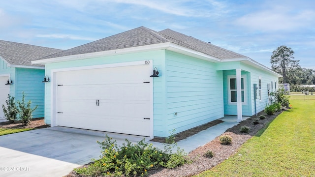 view of side of home with a lawn and a garage