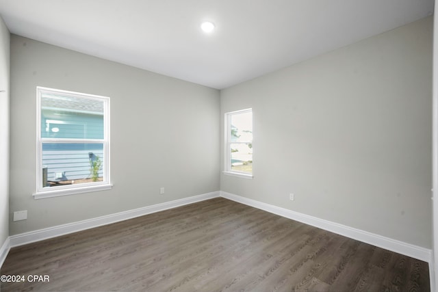 unfurnished room featuring dark wood-type flooring