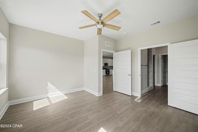 unfurnished bedroom with hardwood / wood-style flooring and ceiling fan