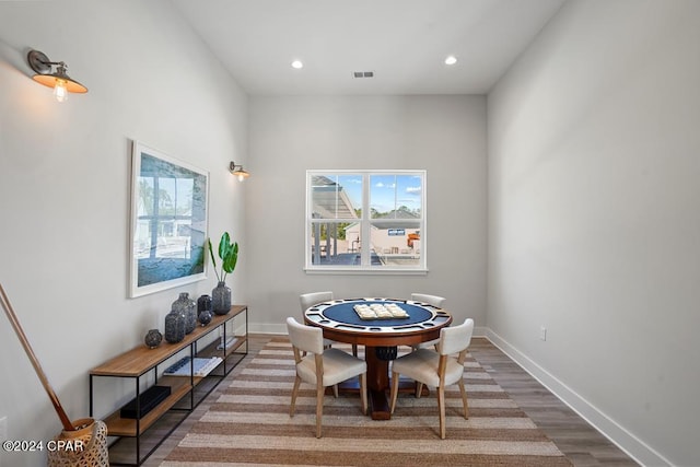 dining space with wood-type flooring