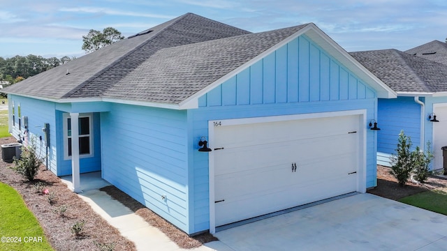 exterior space with a garage and central AC