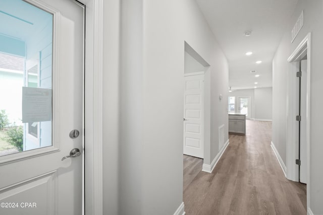 corridor with light wood-type flooring