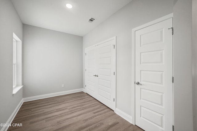 unfurnished bedroom featuring hardwood / wood-style flooring and a closet