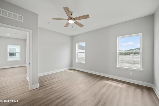 spare room featuring light wood-type flooring and ceiling fan