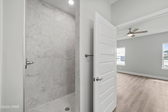 bathroom with ceiling fan, hardwood / wood-style floors, and tiled shower