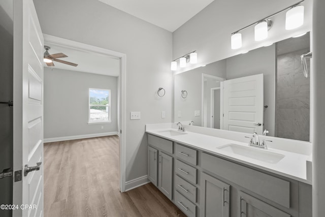 164 Canvas Ln Unit 72, Port St Joe, FL 32456 - full bathroom with double vanity, a ceiling fan, wood finished floors, and a tile shower