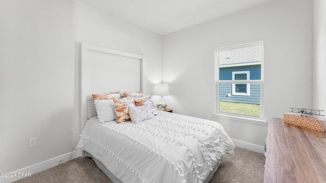 bedroom featuring carpet and baseboards