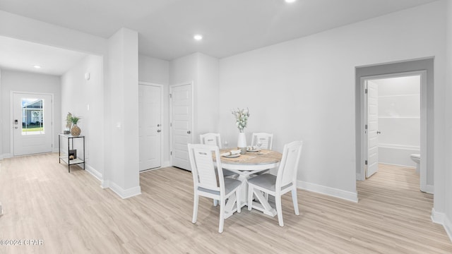 dining room with recessed lighting, light wood-type flooring, and baseboards