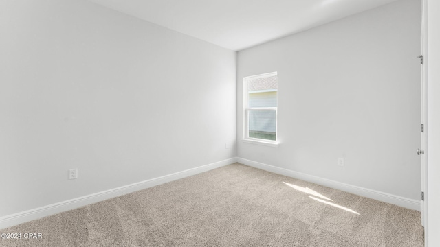 carpeted spare room with baseboards