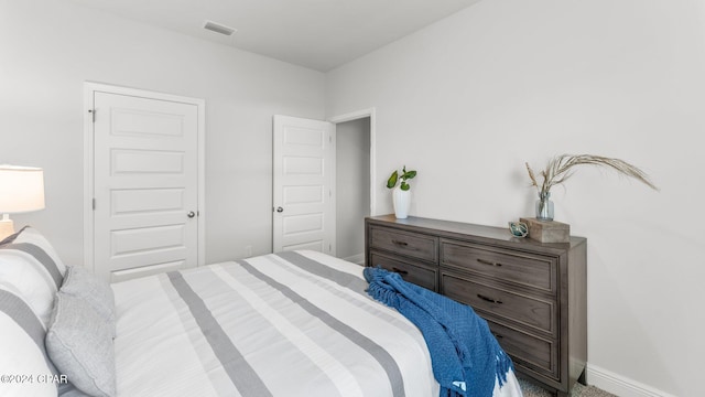 bedroom with baseboards and visible vents