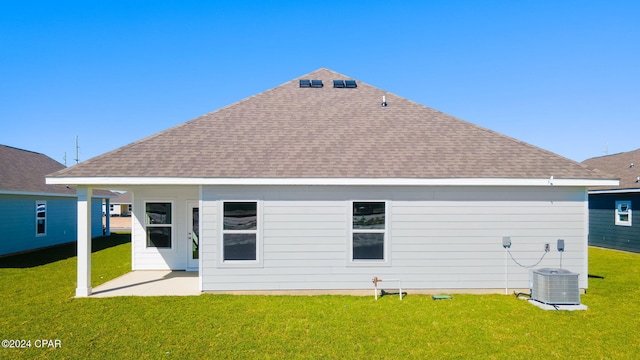 rear view of house with a yard, central AC unit, and a patio area