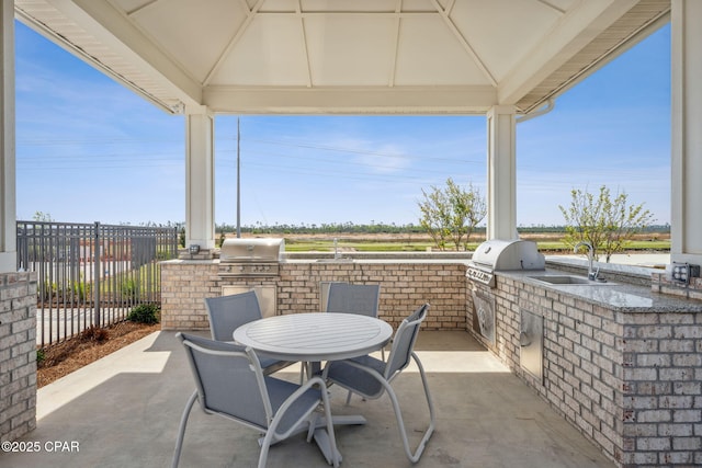 view of patio / terrace with a sink, a gazebo, and a grill