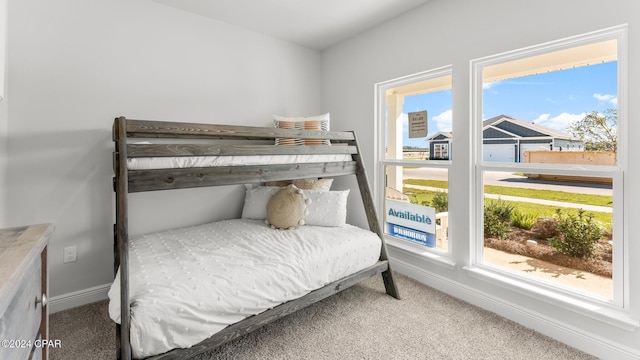 carpeted bedroom featuring baseboards